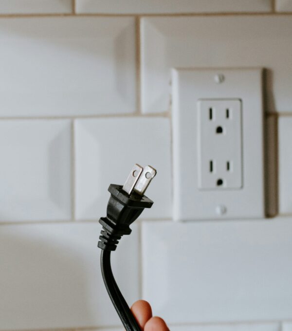 black usb cable plugged in white electric socket